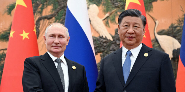 Wladimir Putin und Xi Jinping schütteln die Hände