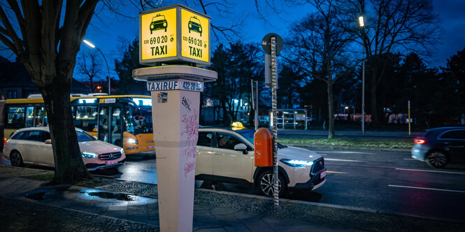 Eine beleuchtete Taxirufsäule in der Nacht