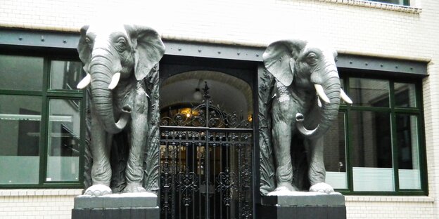 zwei Elefanten-Plastiken säumen eine Eingangstür