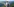 Wanderin vor Landschaft mit Rucksack mit Solarzellen