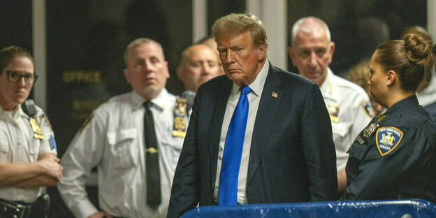 Donald Trump geht an uniformierten Polizisten vorbei