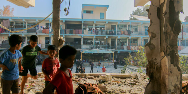 Kinder in einem zerstörten Gebäude.