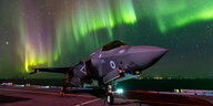 Ein Kampfjet unter Polarlichtern.