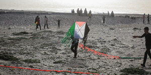 Ein palästinensischer Junge hält einen als palästinensische Flagge gefärbten Drachen während einer von der Mayasem Association for Culture and Arts organisierten Veranstaltung am Strand von Chan Junis.