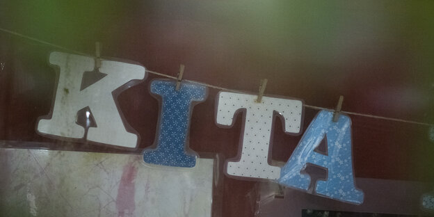An einer Wäscheleine hängen die Buchstaben K, I, T & A