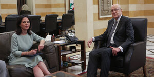 Baerbock und Libanons Premier Mikati sitzen auf Sesseln um ein Tisch