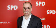 Niels Annen vor einer roten Wand mit SPD-Logos