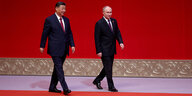 Xi Jinping und Wladimir Putin gehen über einen roten Teppich