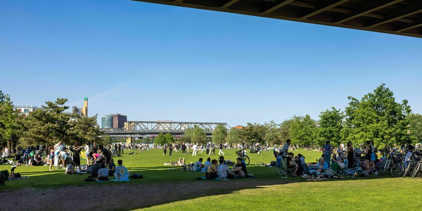 Ein Tag im Sommer, Menschen sitzen unter der Brücke als Schutz vor Hitze