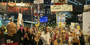 Protestierende halten Fotos von Geiseln in die Höhe