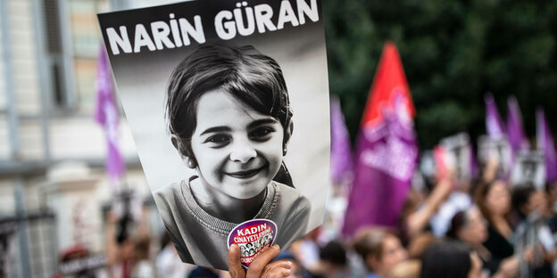 Eine Demonstrantin hält ein Plakat mit dem Namen und dem Foto von Narin Güran