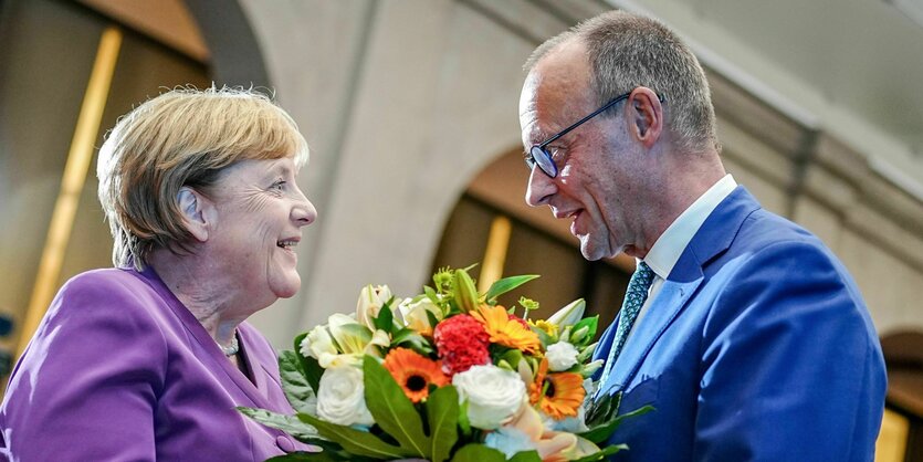 Friedrich Merz überreicht Angela Merkel Blumen