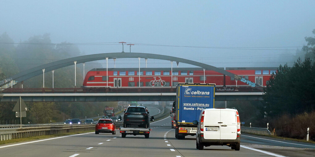 Ein Regionalzug über der Autobahn.