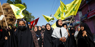 Frauen und Mädchen tragen Hisbollah-Fahnen