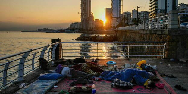 Menschen liegen schlafend in der Corniche von Beirut