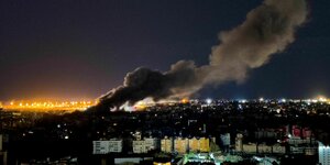 Rauchwolken über Beirut, im Hintergrund deutet sich der Sonnenaufgang an