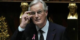 Frankreichs Premierminister Michel Barnier rückt seine Brille zurecht, während er eine Rede in der Nationalversammlung hält