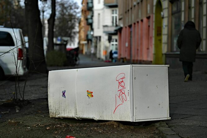 Ein weggeworfener Kühlschrank liegt auf einem Gehweg in Berlin