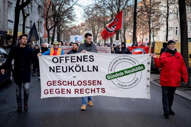 Demonstranten halten ein Banner mit der Aufschrift "Offenes Neukölln"