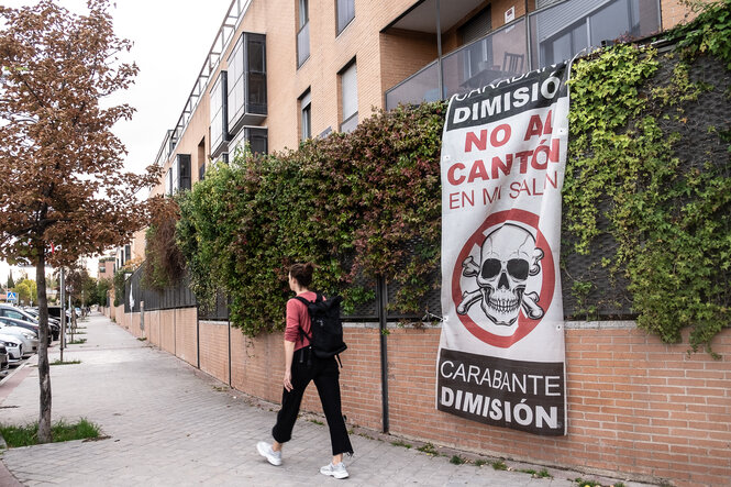 Plakat mit Totenkopf hängt an einem Zaun