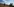 Mann von hinten auf einem Feld, Hände mit Fernglas vors Gesicht gehoben