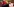 Unscharf im Vordergrund eine bunte Mütze, hinten am Tisch sitzt ein kahler Mann mit Krawatte, es ist Kanzleramtsminister Peter Altmaier (CDU), der auch für Geheimdienste zuständig ist