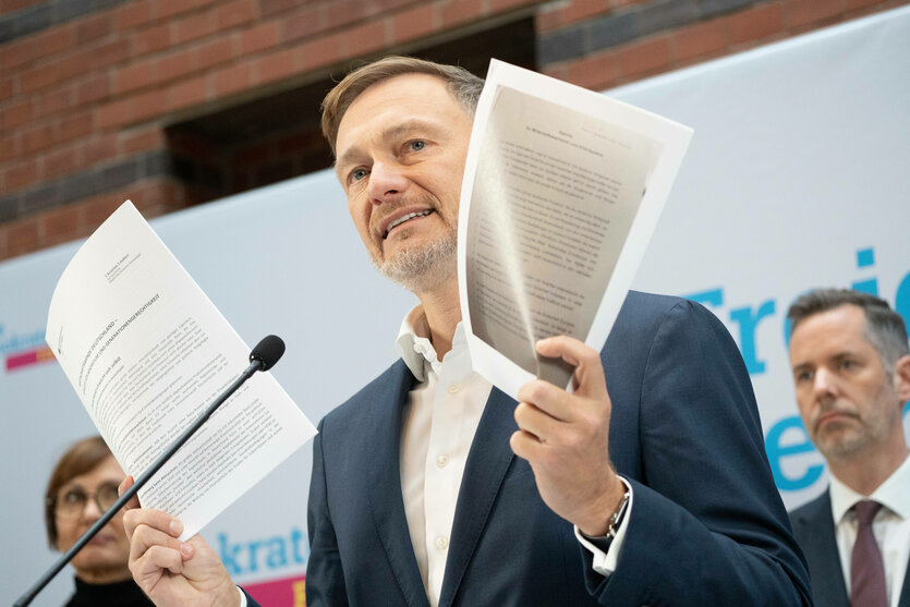 Christian Lindner steht mit Paperen in der Hand bei einer Pressekonferenz.