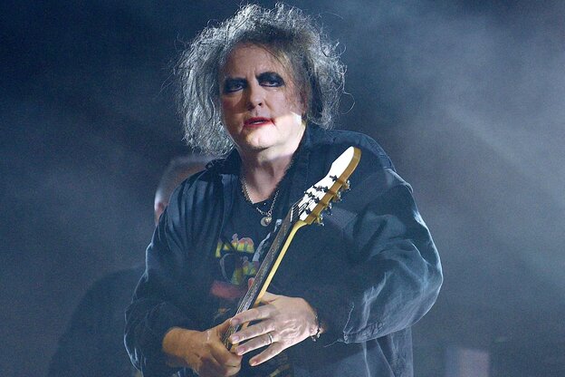 Robert Smith an der Gitarre bei einem Konzert.