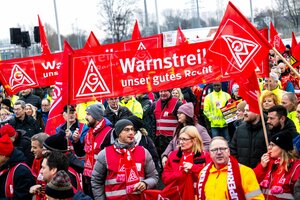 Streikende stehen vor dem Volkswagen-Werk Emden