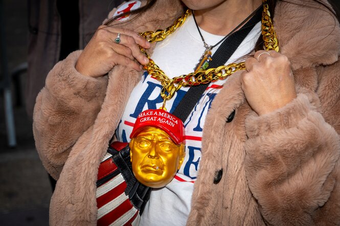 Trump Anhängerin mit goldener Trump-Kette und Make America great again Basecap