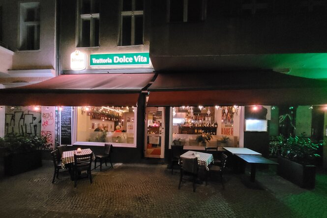 Blick von einer dunklen Straße in ein erleuchtetes Restaurant