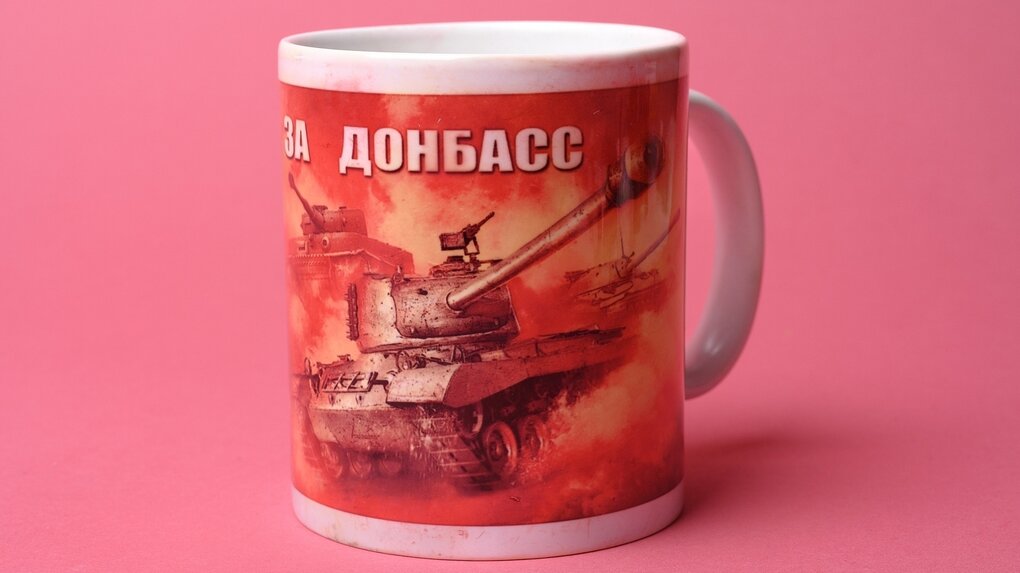 Ein Kaffeebecher, auf dem ein russischer Panzer aufgedruckt ist und die Aufschrift "Für den Donbass"