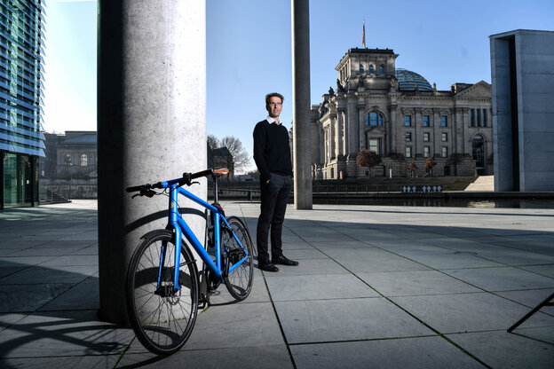 Heinrich Strößenreuther steht im Regierungsviertel, im Hintergrund der Reichtstag, im Vordergrund sein Fahrrad