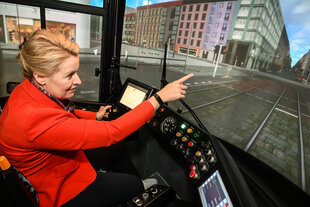 Fraziska Giffey sitzt in einem Straßenbahnsimulator