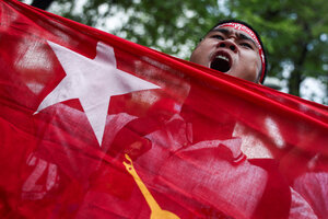 FILE PHOTO: A protester holds a flag as he shouts slogans during a demonstration to mark the third anniversary of Myanmar’s 2021 military coup, outside of the United Nations office in Bangkok, Thailand, February 1, 2024. REUTERS/Chalinee Thirasupa/File Ph