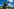 Kuh auf der Alm vor blauem Sommerhimmel