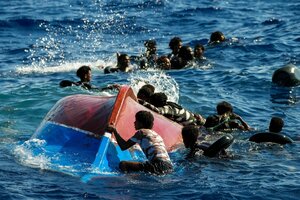 Afrikanische Migranten schwimmen neben ihrem umggstürzten Holzboot