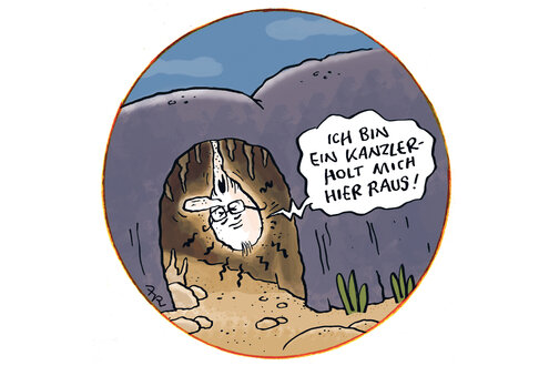 Farbiger Cartoon: Eingang in eine Höhle, aus dem schaut Merz kopfüber heraus und ruft: Ich bin ein Kanzler. Holt mich hier raus!