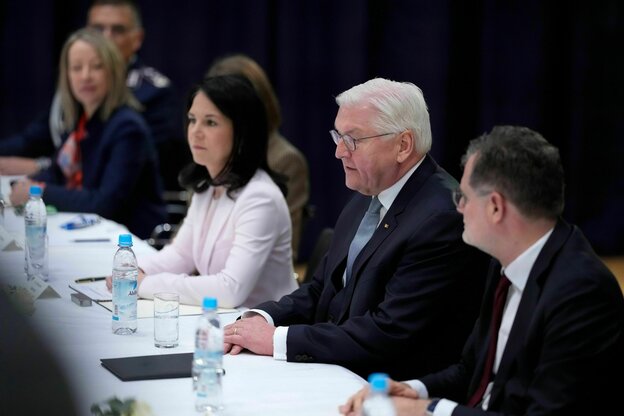 Annalena Baerbock, Frank Walter Steinmeier und andere sitzen an einem Verhandlungstisch