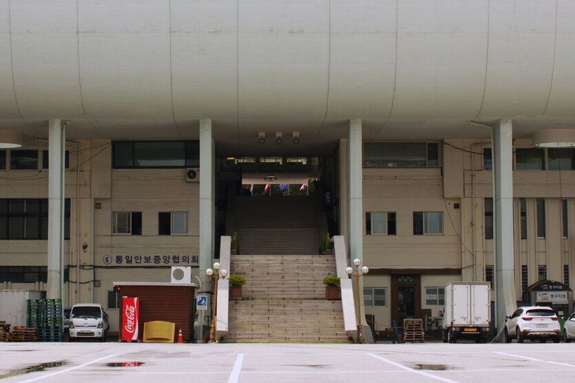 Blick auf ein Verwaltungsgebäude in Südkorea, dessen Dach sich mit einem tiefen Vorsprung abhebt.