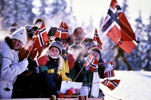 Zuschauer und Zuschauerinnen jubeln und winken mit norwegischen Fahnen