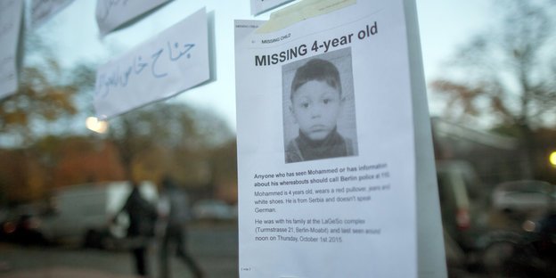 Vermissten-Meldung zum vierjährigen Mohamed klebt auf einer spiegelnden Fensterfläche