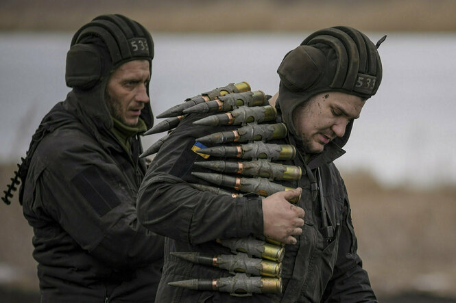 Ukrainische Soldaten tragen Munition.