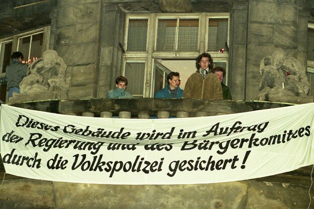 Menschen auf einem Balkon mit Banner
