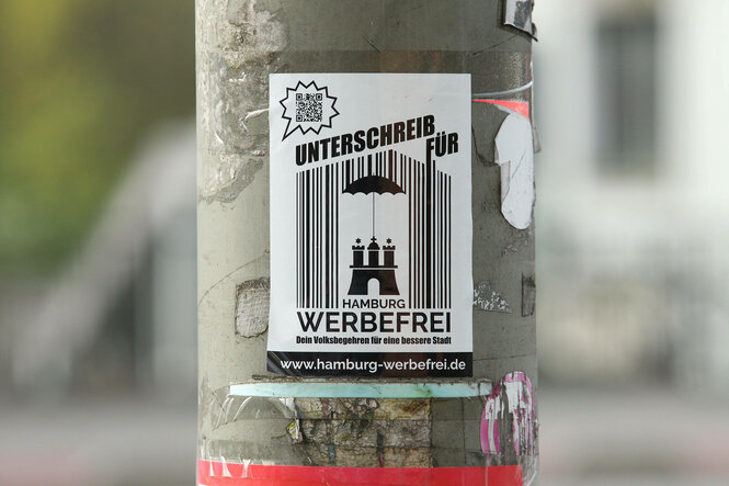 Werbung für eine Stadt mit weniger Werbung auf einem Laternenpfahl