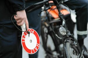 Ein Polizist kontrolliert Radfahrer