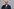 Friedrich Merz fasst sich an ein Ohrläppchen