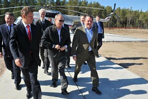 Putin und Schröder laufen lachend mit Begleitern vor einem Helikopter
