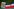 Gerahmtes Bild von Josip Broz Tito neben jugoslawischer Flagge
