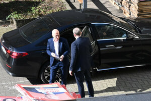 Peter Tschentscher steigt aus einem Auto, dessen Tür ein Mann aufhält. Im Vordergrund liegen SPD-Wahlplakate